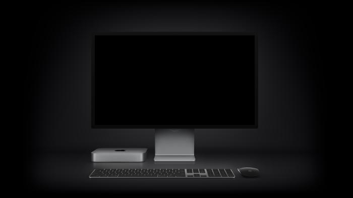 Apple's M2 Mac mini shown with a desktop Apple monitor, keyboard and mouse