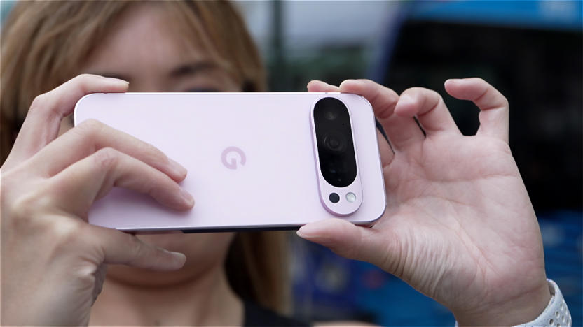 A person holding up a pink Pixel 9 Pro to take a picture.