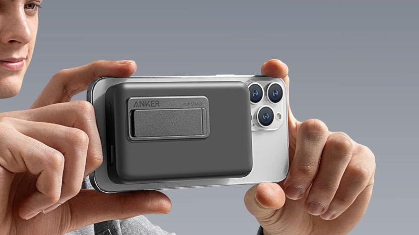 Anker 633 MagSafe-enabled charger attached to an iPhone that someone is holding as if they're framing a photo.