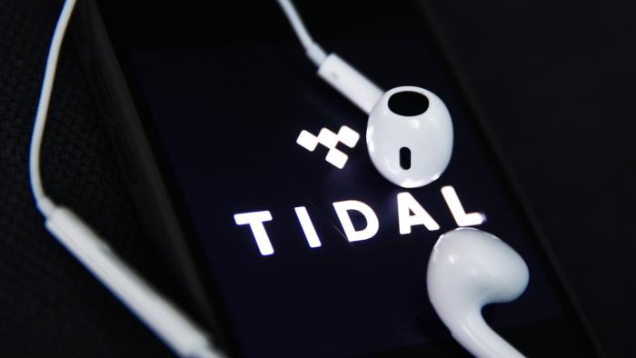 Headphones and Tidal logo displayed on a phone screen are seen in this illustration photo taken in Krakow, Poland on December 5, 2023. (Photo by Jakub Porzycki/NurPhoto via Getty Images)