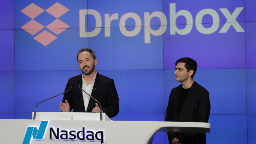 Dropbox Inc. co-founder Drew Houston speaks in front of co-founder Arash Ferdowsi celebrate as Dropbox (DBX) is listed for the company's initial public offering (IPO) at the Nasdaq Market Site in New York, U.S., March 23, 2018.  REUTERS/Lucas Jackson