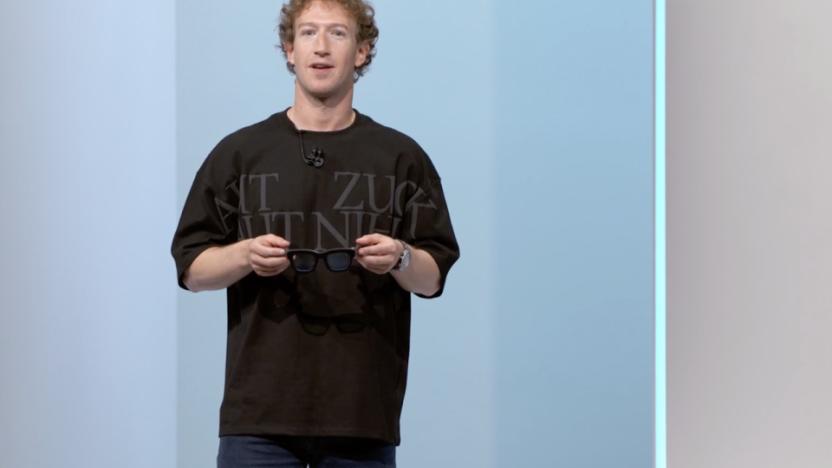 Mark Zuckerberg onstage holding glasses.