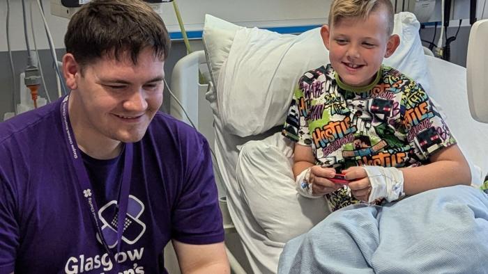 Gamer-in-Residence, Steven Mair (26) plays with eight-year-old patient Martin at the Royal Hospital for Children in Glasgow, Scotland.